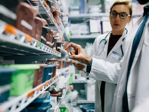 Pharmacy staff taking stock of medicine.
